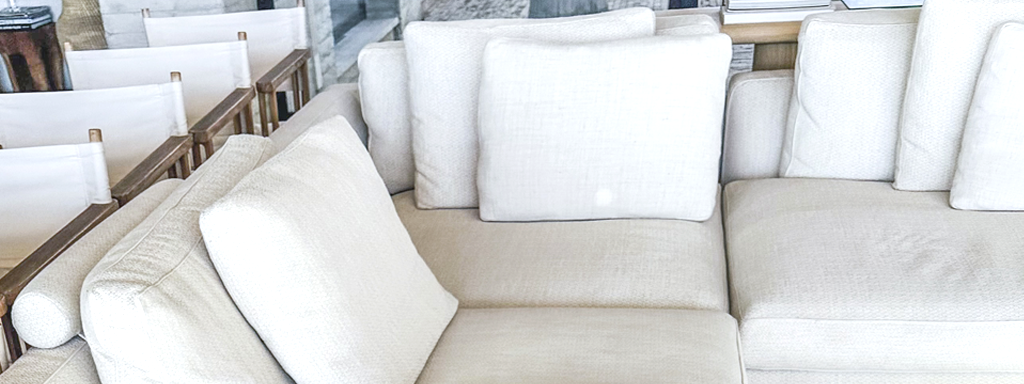 Modern beige sectional sofa in a stylish living room with wooden chairs.- **Title:** Contemporary Beige Sectional Sofa in Living Room- **Caption:** A chic beige sectional sofa enhances the elegance of a modern living room.- **Description:** This image showcases a contemporary beige sectional sofa set in a stylish living room. The sofa's neutral tones complement the wooden chairs and add a touch of elegance to the space. Perfect for modern interior design enthusiasts looking to enhance their living room with chic and comfortable seating options.